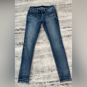 Buckle black skinny jeans